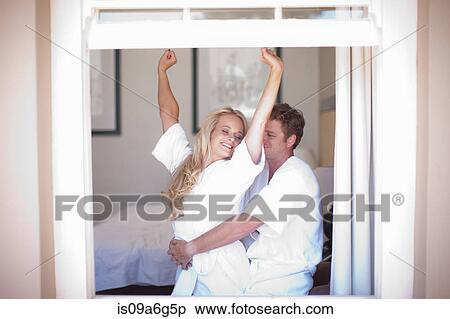 Young couple wearing bathrobes by window View Large Photo Image Stock Photography - Young couple wearing bathrobes by window. Fotosearch