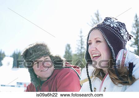 Stock Image - Young couple wearing hats. Fotosearch