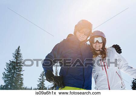 Stock Photo - Young couple wearing skiwear. Fotosearch