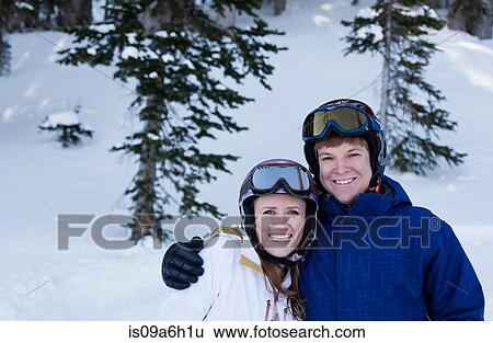 Stock Photograph - Young couple wearing skiwear. Fotosearch