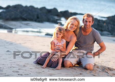 Stock Photograph - Young family with daughter on beach. Fotosearch