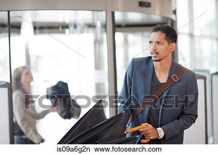Young man arriving with umbrella View Large Photo Image Picture - Young man arriving with umbrella. Fotosearch
