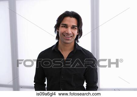 Picture - Young man in front of window, portrait. Fotosearch