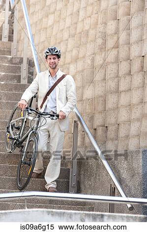 Young man on steps with bicycle View Large Photo Image Stock Photography - Young man on steps with bicycle. Fotosearch