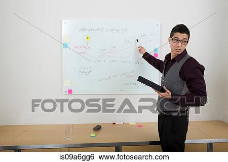 Young man using whiteboard View Large Photo Image Stock Photograph - Young man using whiteboard. Fotosearch