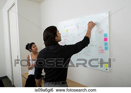Stock Photograph - Young man using whiteboard. Fotosearch