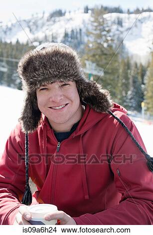 Picture - Young man wearing furry hat. Fotosearch