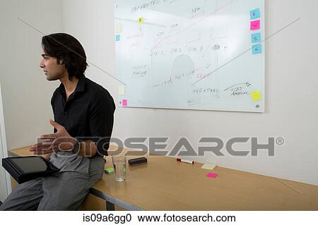 Young man with whiteboard in background View Large Photo Image Stock Image - Young man with whiteboard in background. Fotosearch