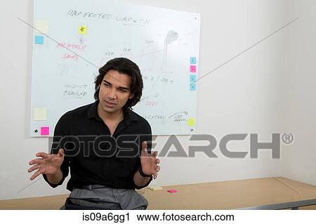 Young man with whiteboard in background View Large Photo Image Stock Image - Young man with whiteboard in background. Fotosearch