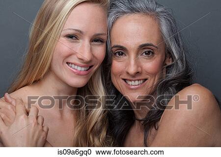 Stock Image - Young woman and mature woman hugging. Fotosearch