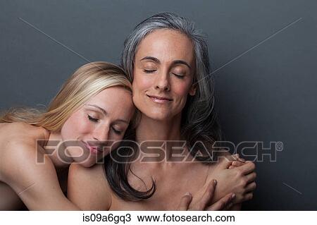 Young woman and mature woman hugging View Large Photo Image Stock Image - Young woman and mature woman hugging. Fotosearch