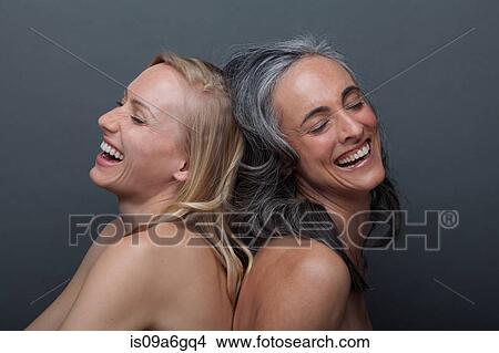 Picture - Young woman and mature woman laughing. Fotosearch