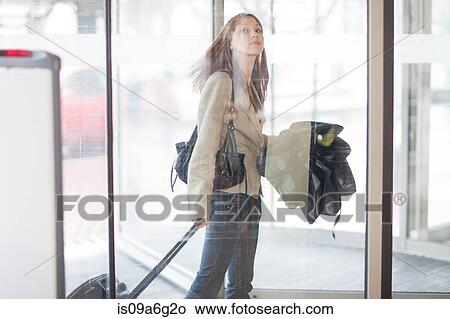 Young woman arriving at airport terminal View Large Photo Image Picture - Young woman arriving at airport terminal. Fotosearch