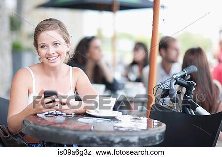 Young woman at cafe View Large Photo Image Stock Photo - Young woman at cafe. Fotosearch