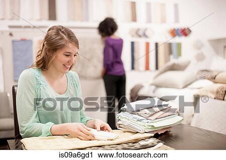 Young woman at desk with fabric samples View Large Photo Image Stock Image - Young woman at desk with fabric samples. Fotosearch