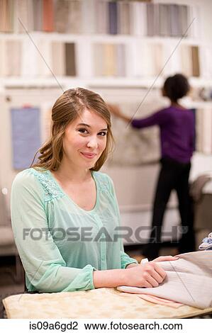 Young woman at desk with fabric samples View Large Photo Image Stock Image - Young woman at desk with fabric samples. Fotosearch