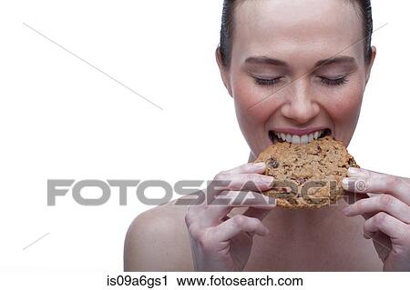 Young woman biting cookie View Large Photo Image Stock Image - Young woman biting cookie. Fotosearch