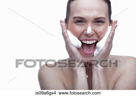 Picture - Young woman cleansing face. Fotosearch
