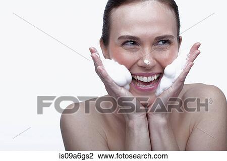 Young woman cleansing face View Large Photo Image Stock Image - Young woman cleansing face. Fotosearch