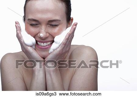 Young woman cleansing face View Large Photo Image Stock Image - Young woman cleansing face. Fotosearch