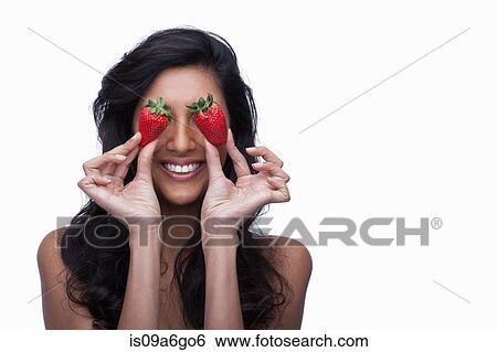 Young woman covering eyes with strawberries View Large Photo Image Stock Photograph - Young woman covering eyes with strawberries. Fotosearch