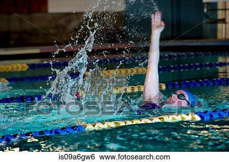 Stock Photograph - Young woman doing backstroke in swimming pool. Fotosearch