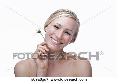 Stock Photo - Young woman holding daisy. Fotosearch