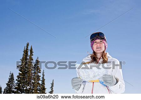Young woman holding ski map View Large Photo Image Stock Image - Young woman holding ski map. Fotosearch