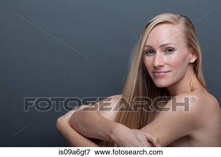 Stock Photo - Young woman hugging herself. Fotosearch