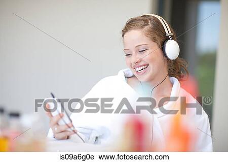 Young woman listening to MP3 player View Large Photo Image Stock Image - Young woman listening to MP3 player. Fotosearch