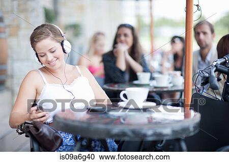 Young woman listening to music View Large Photo Image Stock Image - Young woman listening to music. Fotosearch