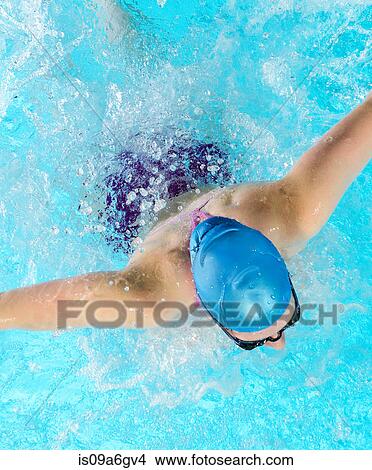 Picture - Young woman swimming in swimming pool. Fotosearch