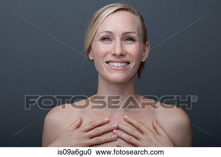 Young woman touching chest View Large Photo Image Stock Image - Young woman touching chest. Fotosearch