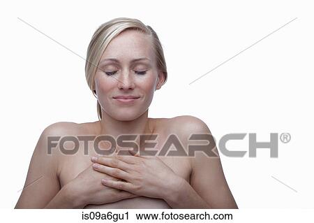 Stock Image - Young woman touching chest. Fotosearch