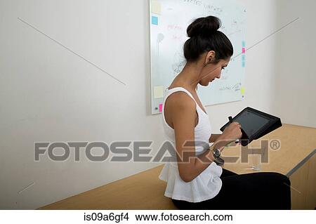Young woman using digital tablet View Large Photo Image Picture - Young woman using digital tablet. Fotosearch