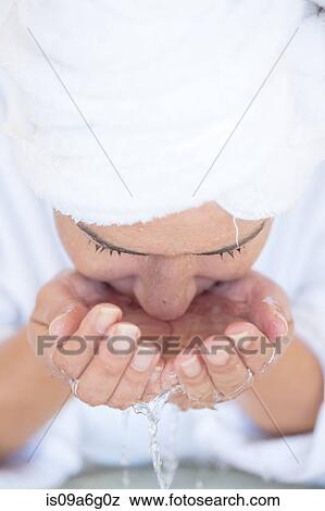 Stock Photo - Young woman washing face. Fotosearch