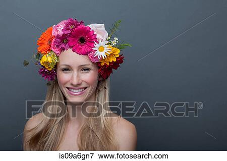 Stock Photo - Young woman wearing garland of flowers on head. Fotosearch