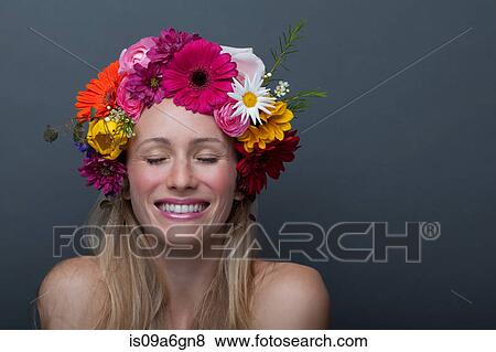 Stock Photo - Young woman wearing garland of flowers on head. Fotosearch