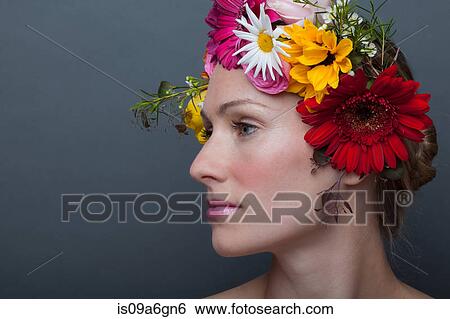 Young woman wearing garland of flowers on head View Large Photo Image Stock Photograph - Young woman wearing garland of flowers on head. Fotosearch