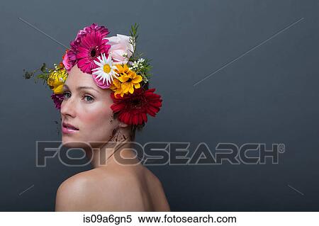 Stock Photography - Young woman wearing garland of flowers on head. Fotosearch