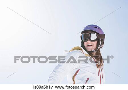 Young woman wearing ski goggles and helmet View Large Photo Image Stock Photo - Young woman wearing ski goggles and helmet. Fotosearch