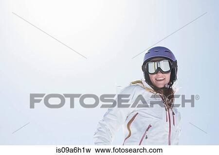 Young woman wearing ski goggles and helmet View Large Photo Image Stock Photo - Young woman wearing ski goggles and helmet. Fotosearch