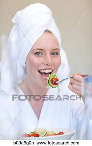 Young woman wearing towel on head eating salad View Large Photo Image Picture - Young woman wearing towel on head eating salad. Fotosearch