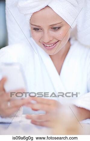 Stock Image - Young woman wearing towel on head. Fotosearch