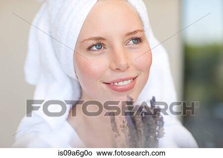 Picture - Young woman wearing towel on head with lavender. Fotosearch