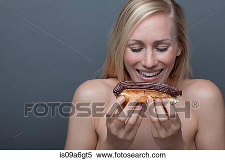 Young woman with chocolate eclair View Large Photo Image Stock Photography - Young woman with chocolate eclair. Fotosearch