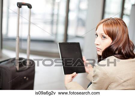 Stock Photo - Young woman with digital tablet. Fotosearch