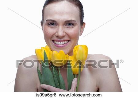 Young woman with flower in hair and hands on face View Large Photo Image Stock Photograph - Young woman with flower in hair and hands on face. Fotosearch