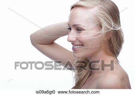 Stock Image - Young woman with hand in hair. Fotosearch