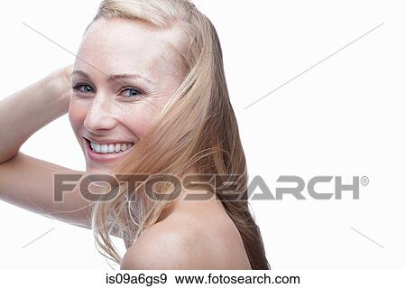 Stock Photo - Young woman with hand in hair. Fotosearch